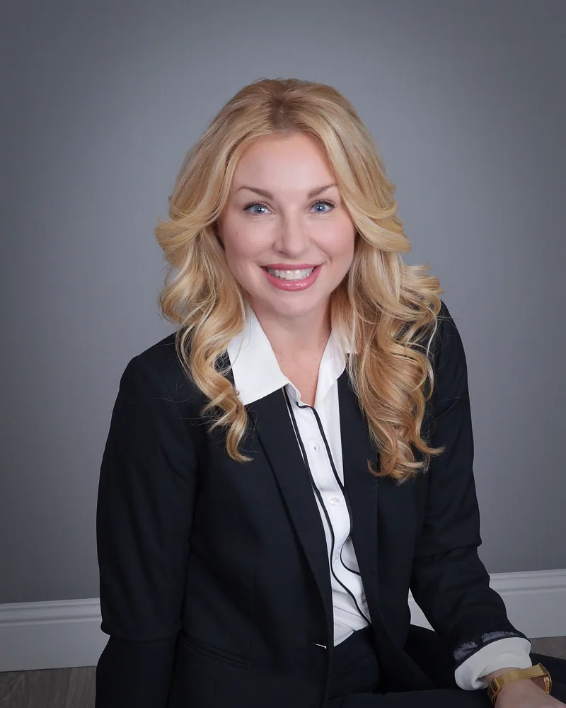 Brittani Preschel, CEO and Founder of D2 Advertising, seated in a black business suit